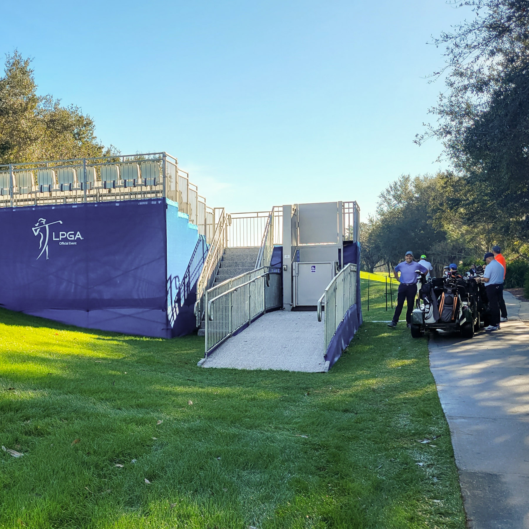 6' ADA Lift Rental at the Hilton Grand Vacations Tournament of Champions. LPGA logo on the blue covering of the hospitality structure.