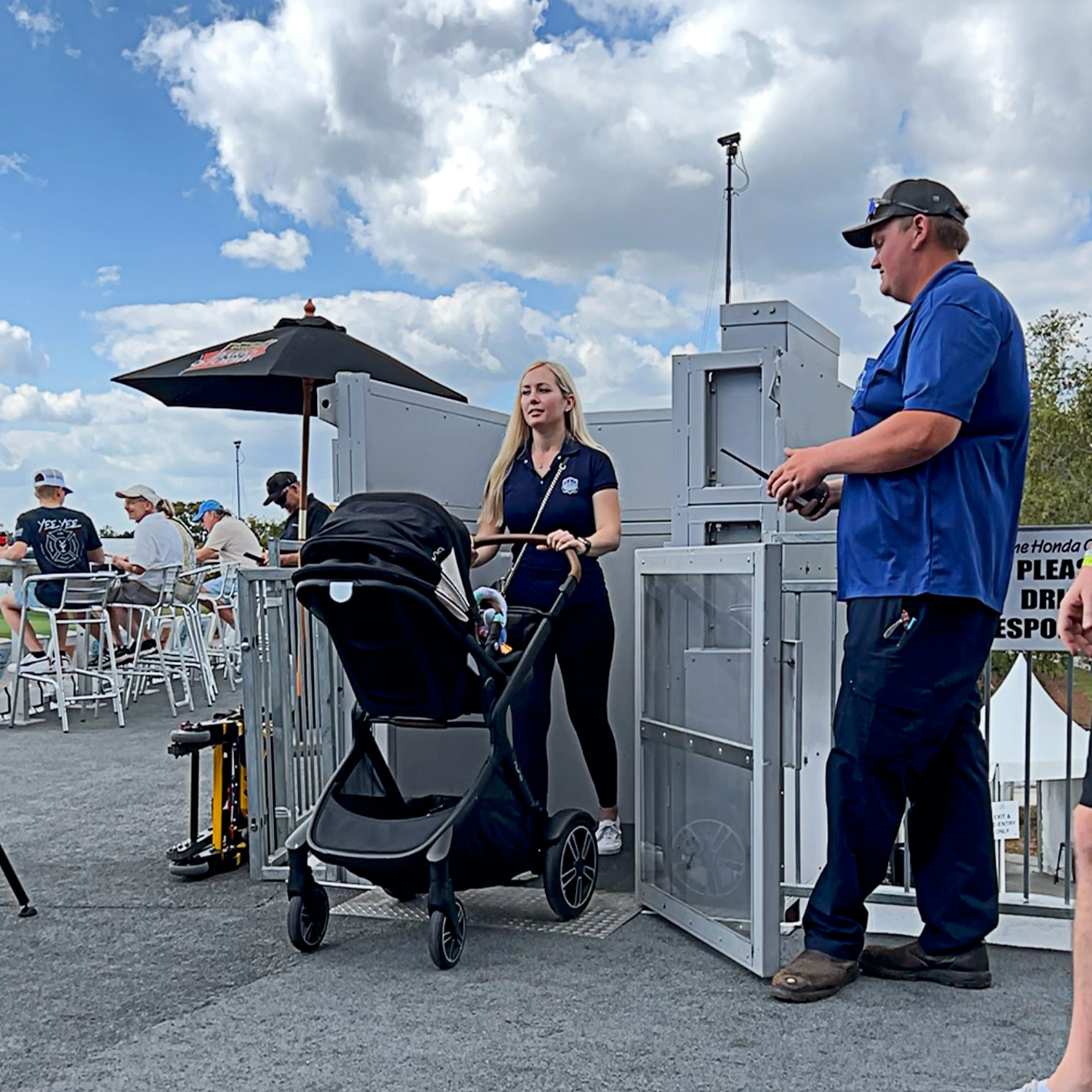 A mother pushing a stroller out of an ADA Lift Rental, assisted by an ADA Lift technician.