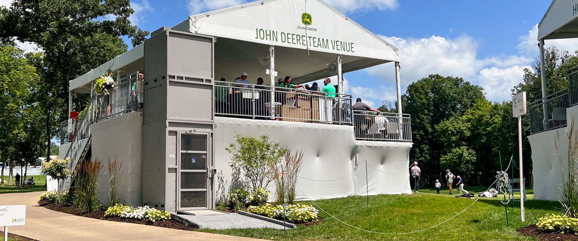 12' ADA wheelchair lift accessing the John Deere Team Venue hospitality structure to bypass the stairs located behind it.
