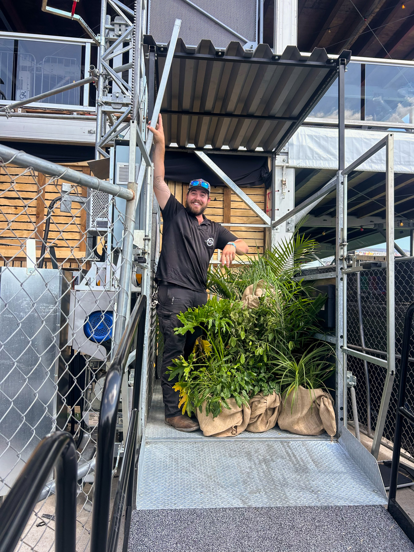 ADA Lift Rentals' technician moving event decor with a transport platform at Louder than Life music festival.