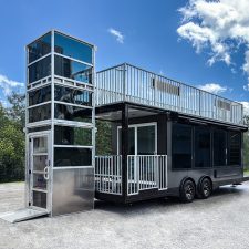 Wheelchair lift access to a Party Shack™ portable hospitality suite. 12' ADA Lift Rental wheelchair lift with tinted plexiglas panels paired with a hospitality suite from Party Shack™