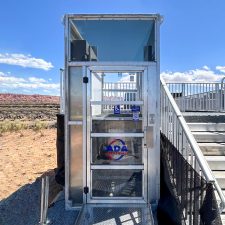 Enclosed, 6' wheelchair lift rental with Plexiglas panels at the LPGA Championship in Utah. 6' Enclosed ADA Lift Rental. Plexiglas panels. Utah desert in the background.